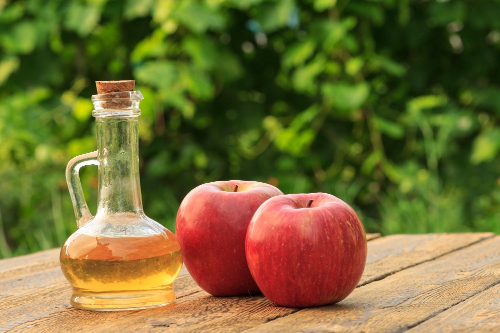 apple-vinegar-glass-bottle-with-cork-fresh-red-apples-old-rustic-wooden-boards