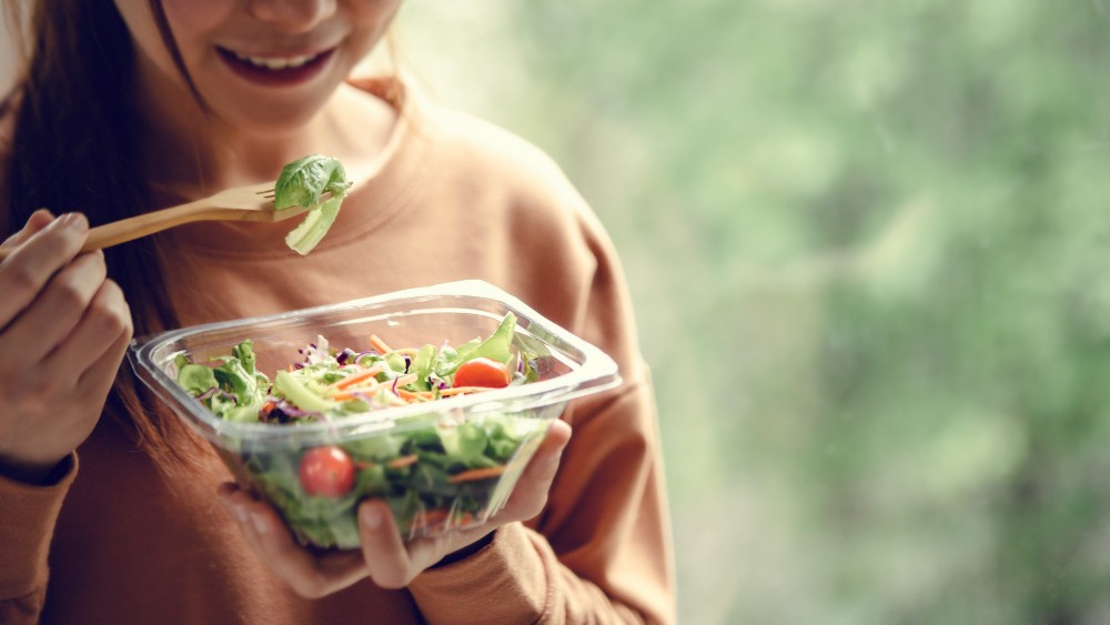 closeup-woman-eating-healthy-food-salad-focus-salad-fork