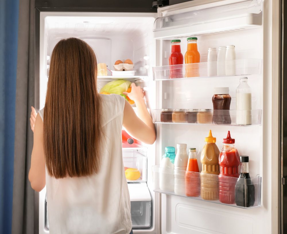 woman-choosing-food-refrigerator-home